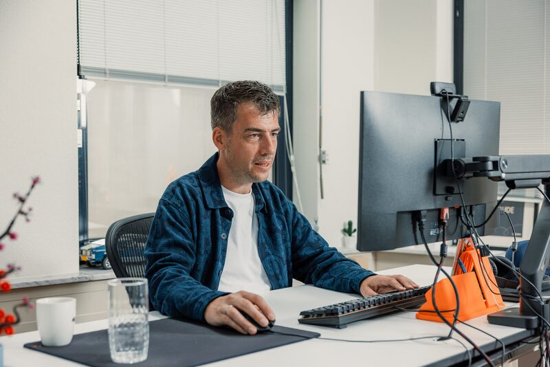 Een opgeruimde werkplek met twee schermen